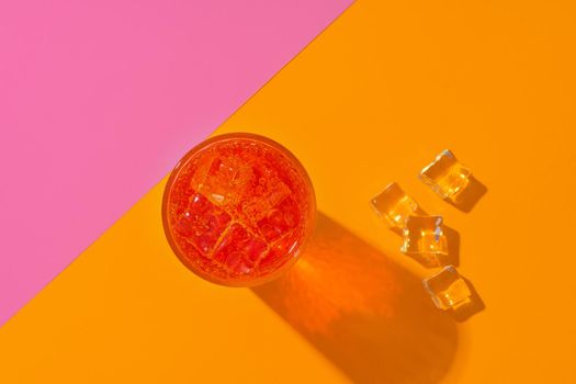 Glass of fresh cocktail on color background