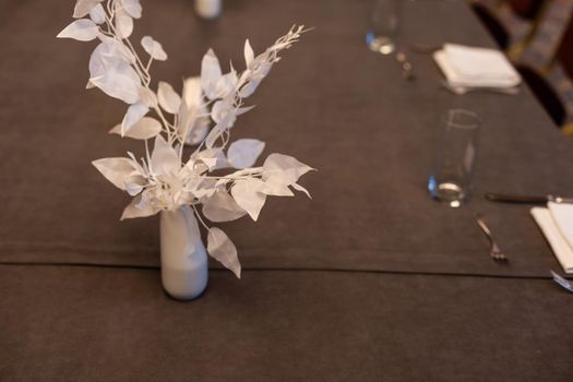 Wedding decor. White paper flowers on a set table