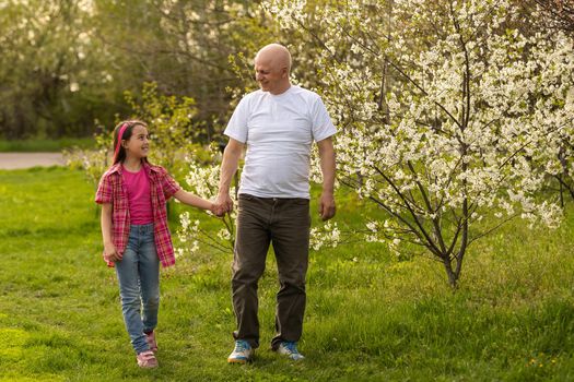 Grandfather And granddaughter on flower farm