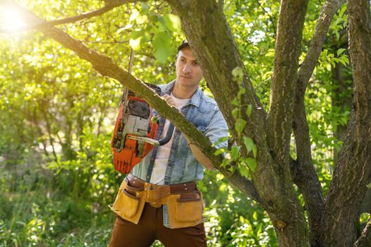 Man cutting a branch with chainsaw