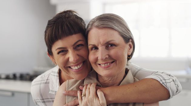 Its been too long. Shot of a mother and daughter embracing at home.