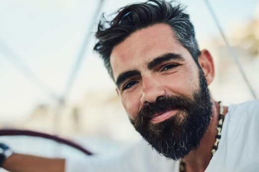 Bearded guy know how to chill. Cropped shot of a handsome mature man on his yacht.