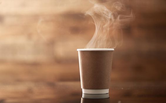 Life happens, a latte will help. Closeup shot of steam rising from a paper cup filled with a warm beverage.
