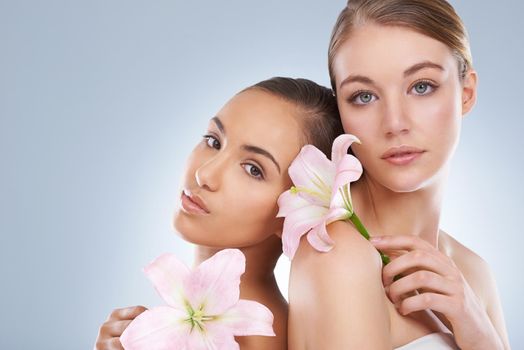 Delicate as an orchid petal. Studio beauty shot of a two young models.