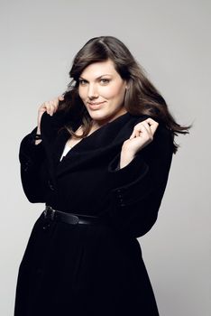 Looking forward to Fall. Studio shot of a plus-size model posing for the camera.