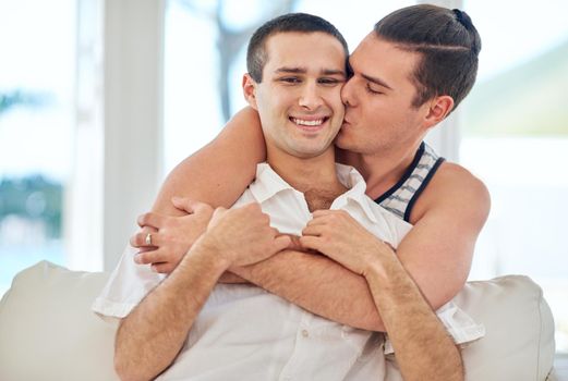 Life together is always special. Shot of a gay couple relaxing together at home.