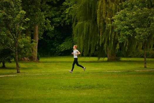 Lone runner. Shot of a woman jogging in a park.