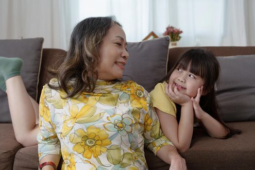 Asian portrait, grandma and granddaughter doing leisure activities and hugging to show their love and care for each other