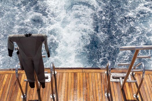 Wetsuit on a stern of the yacht while sailing.