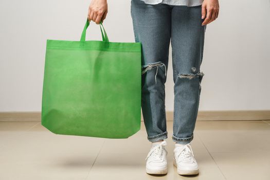 Cropped image of woman holding color shopping bag in studio
