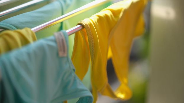 Clean washed clothes are dried in metal dryer closeup