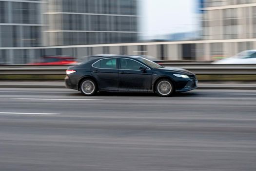 Ukraine, Kyiv - 11 March 2021: Black Toyota Camry car moving on the street. Editorial
