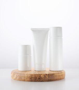 Bottle, empty white plastic tubes for cosmetics. Packaging for cream, gel, serum