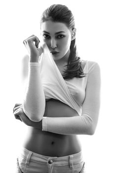 Sexy fashion model posing in white t-shirt and undressing.