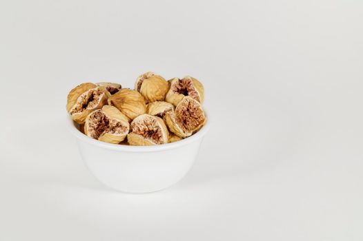 Bowl of dried figs on white