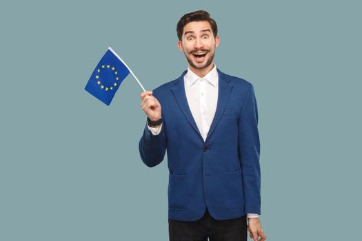 man holding European union flag and looking at camera with wondered face.