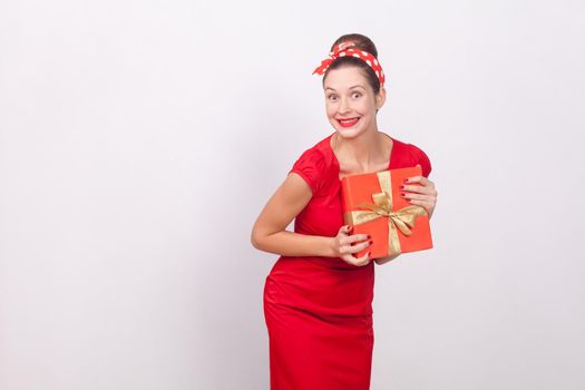 Wonder and happy woman holding gift box