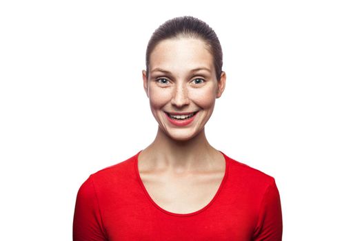 Portrait of happy smiley woman in red t-shirt with freckles. looking at camera with toothy smile,