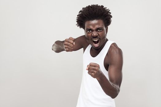 Dangerous fighter. Afro man ready to fight. Studio shot.