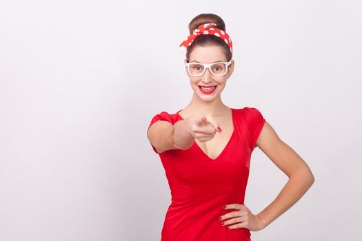 Happiness woman in red dress pointing finger an toothy smile