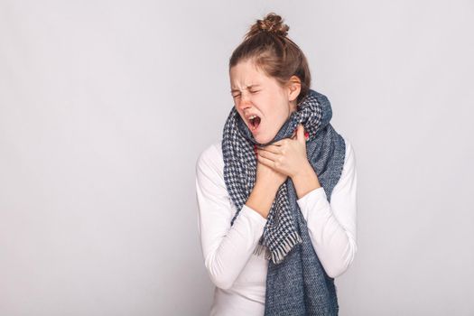 Young adult sick woman touching her neck, have cough, sore throat