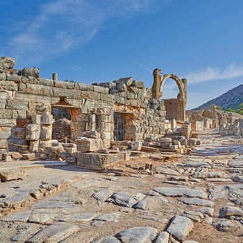 Ancient city ruins of Ephesus in Turkey during the day. Traveling abroad and overseas for holiday, vacation and tourism. Excavated remains of historical building from Turkish history and culture