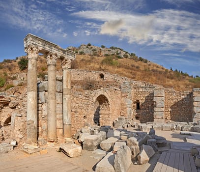 Ancient city ruins and pillars of Ephesus in Turkey in the day. Traveling abroad, overseas for holiday, vacation, tourism. Excavated remains of historical stone building in Turkish history, culture