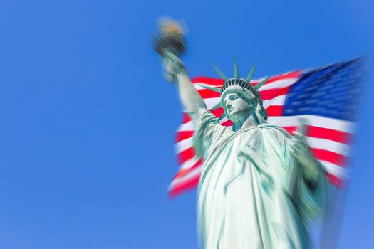Statue of Liberty with a large american flag with motion blur effect
