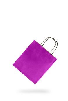 Violet color paper shopping bag on white isolated background. An empty price tag hangs to insert text.