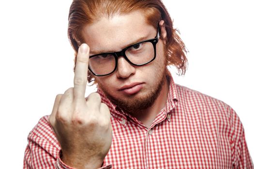 businessman with red shirt and freckles looking at camera and showing middle finger