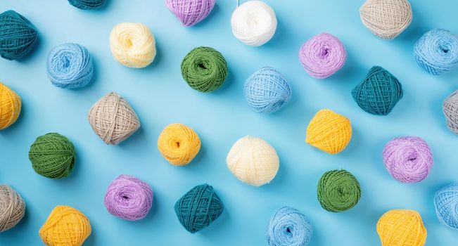 bright and colorful yarn wool pattern on bright background, top view flat lay