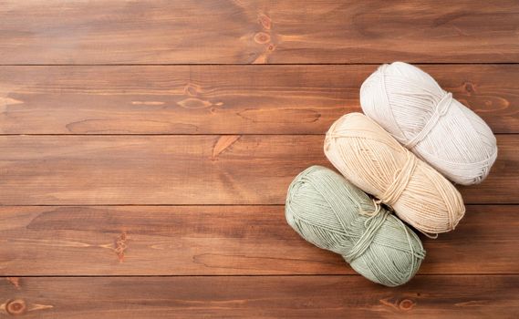 pastel colored yarn wool on wooden background