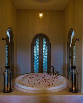 romantic bath tub with rose petals, luxury vacation in jacuzzi