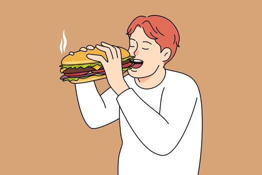 Hungry man eating burger