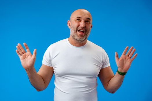 Man over isolated blue background with surprise facial expression.