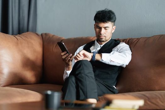 Portrait of Asian Businessman checking schedule and waiting for meet customer.