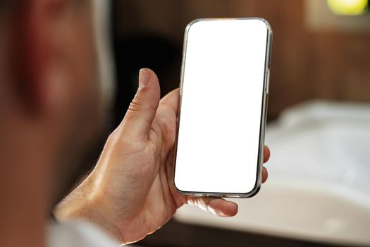 Man using smartphone with blank screen for copy space