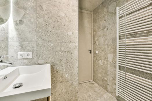 Open shower in gray tiled room