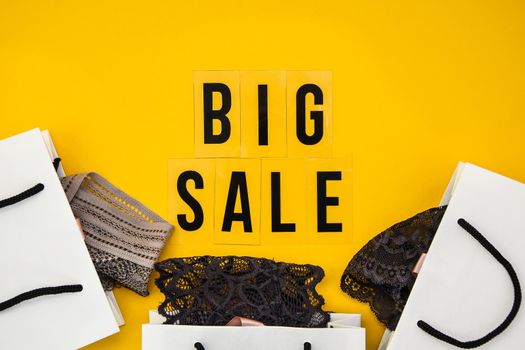 packaging bags, text Big sale on yellow background Top view Flat lay sesonal sale, retail, shopping concept