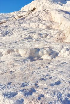 Closeup of travertine pools and terraces in Pamukkale, Turkey. Travelling abroad for holiday and tourism. Cotton castle area with carbonate mineral after flowing thermal spring water