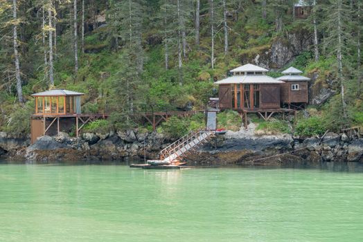 Isolated wood cabins on shoreline of Resurrection Bay