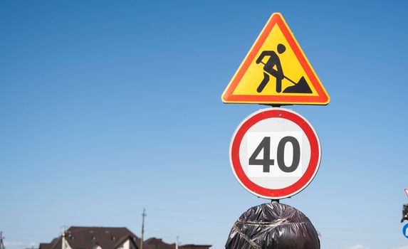 Road marking on the road, warning signs. Direction of detour, sign speed limit 40 and roadworks. Road signs denoting road repairs, speed limit up to 40, detour.