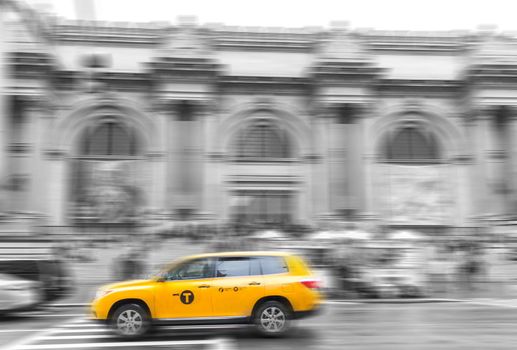 Yellow taxi Cab at The Metropolitan museum in New York City in black and white toning with motion blur effect