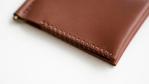 Empty classics brown leather handmade money clip wallet on white background. Leather accessories.