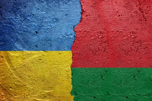 Ukraine and Belarus - Cracked concrete wall painted with a Ukrainian flag on the left and a Belarusian flag on the right stock photo