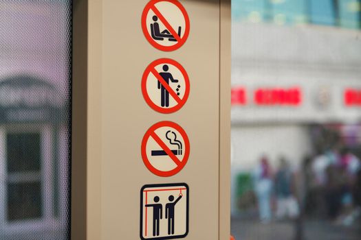 Inside a public bus with icons for prohibitions