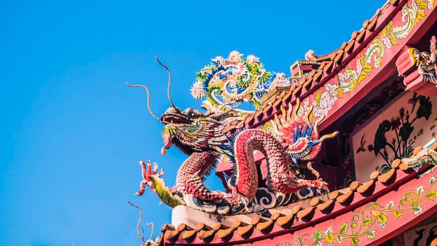 Chinese dragon on the roof of chinese temple.the eaves of a temple in China Dragons on the roof of Heaven Worshiping Palace . Chinese imperial roof decorations