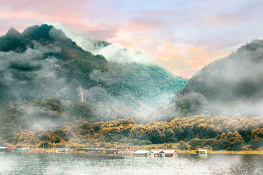 Panorama scenic of Foggy Mountain in Autumn with rafting house on lake.