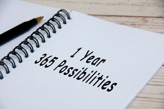 Motivational and inspirational quotes on notepad - 1 year 365 possibilities. Motivational concept