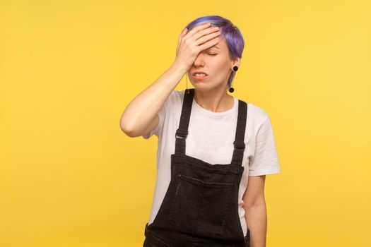 Portrait of emotional hipster woman on yellow background.
